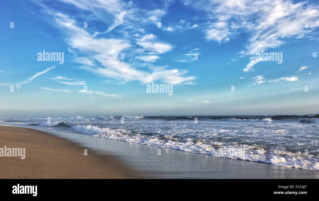 Ocean waves crushing on a sandy beach in California on a sunny but windy March afternoon. 16x9 - Smartphone Captured Stock Image