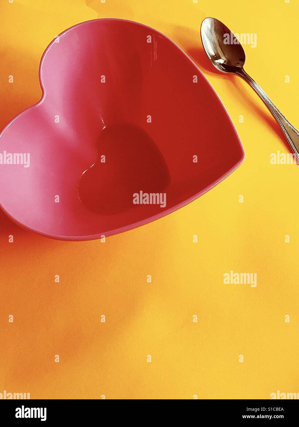 Heart Shaped Bowl with Spoon Stock Photo