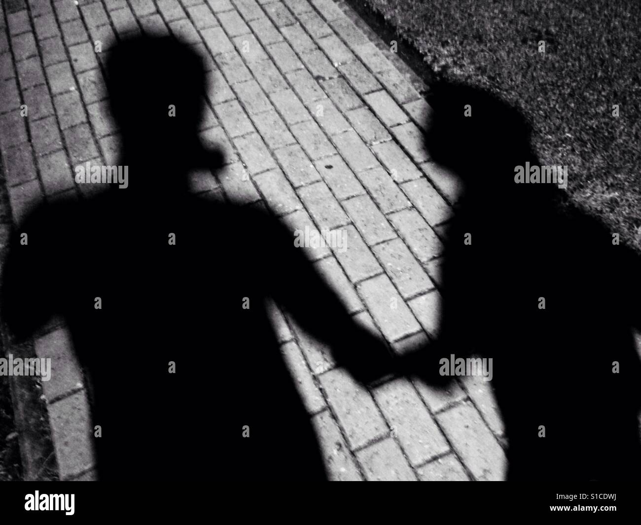 Shadow of Couple Holding Hand - Black and White Stock Photo