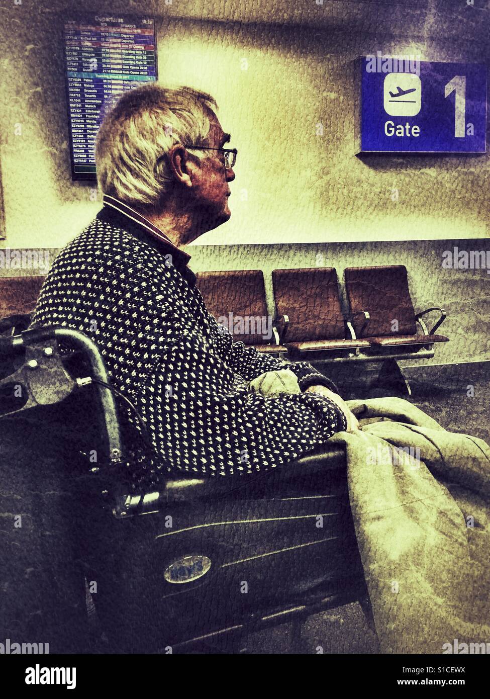 Elderly man in a wheelchair in the area reserved for disabled passengers at Bristol Airport, England - Smartphone Captured Stock Image