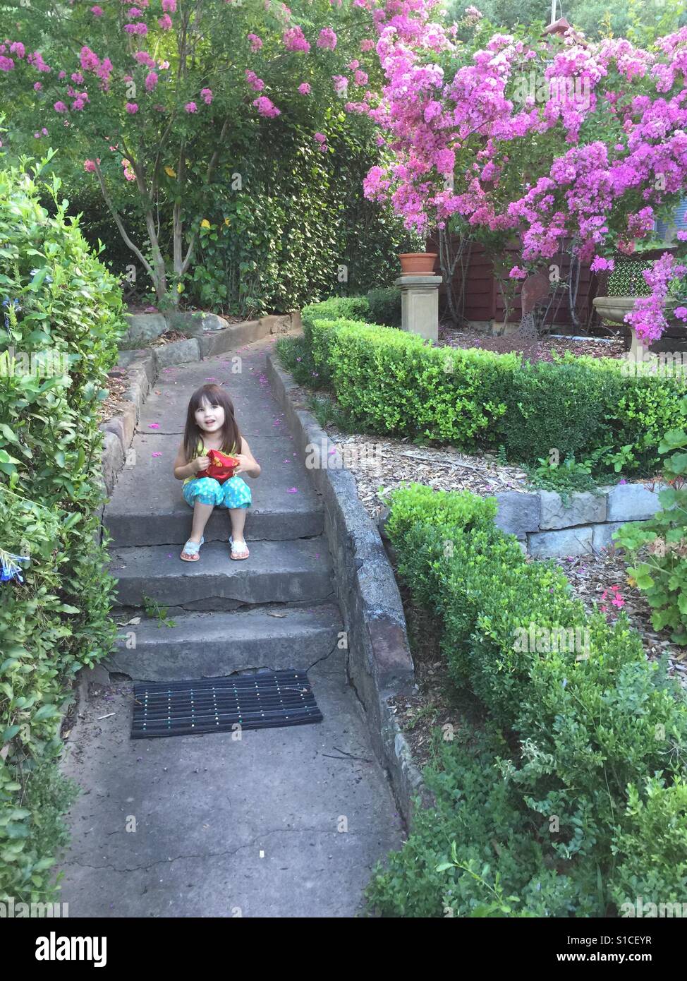 Girl in pretty garden Stock Photo