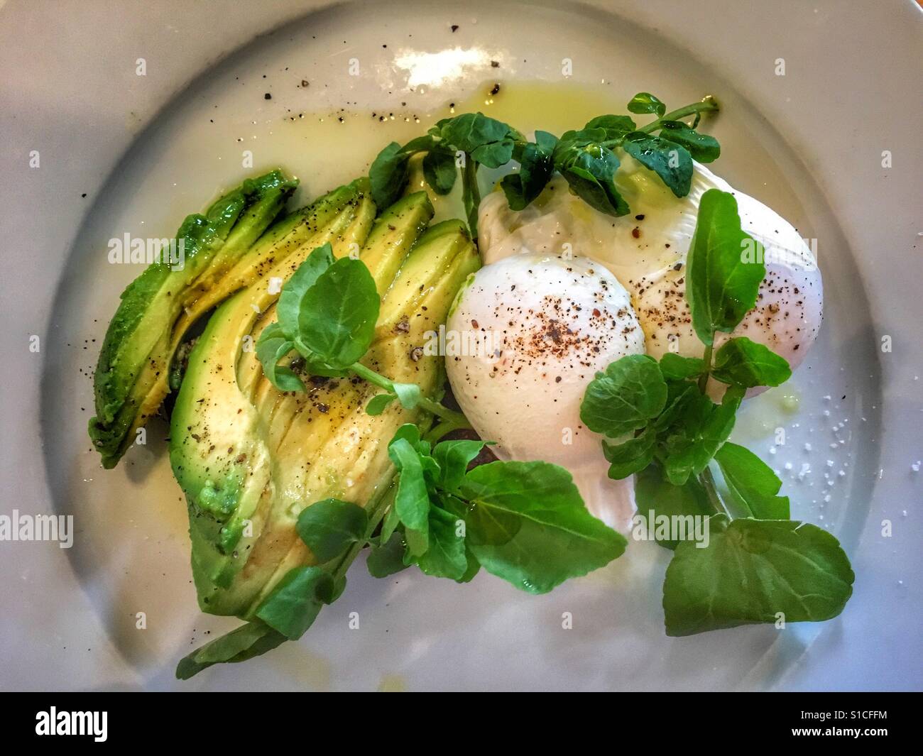 Poached eggs, avocado and pea shoots salad - Smartphone Captured Stock Image
