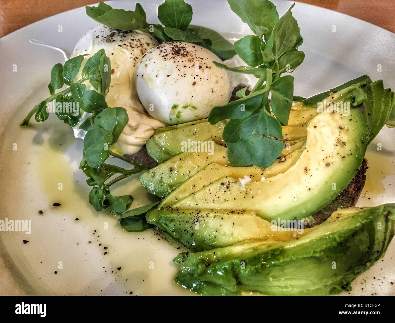 Poached eggs with avocado and pea shoot salad - Smartphone Captured Stock Image