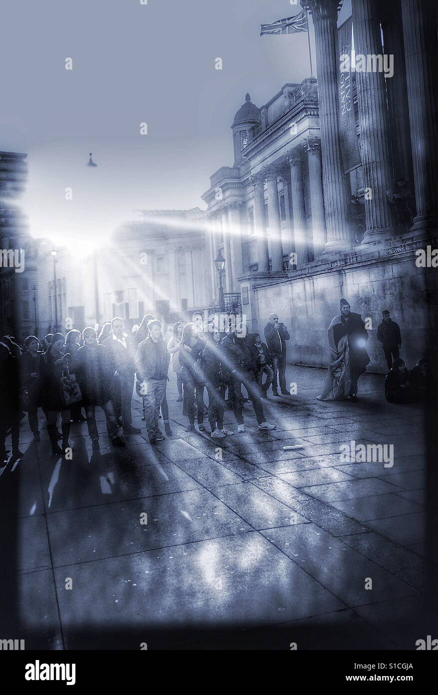 Crowd watching street entertainers in bright sunlight, Trafalgar Square, London Stock Photo
