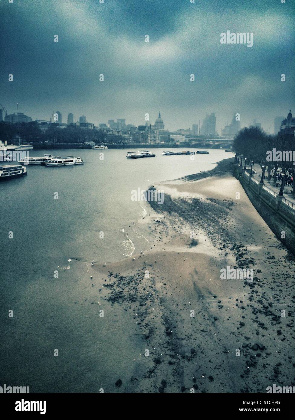 A foggy overcast day on the river Thames in London, UK with St Pauls Cathedral visible on the skyline in the background - Smartphone Captured Stock Image