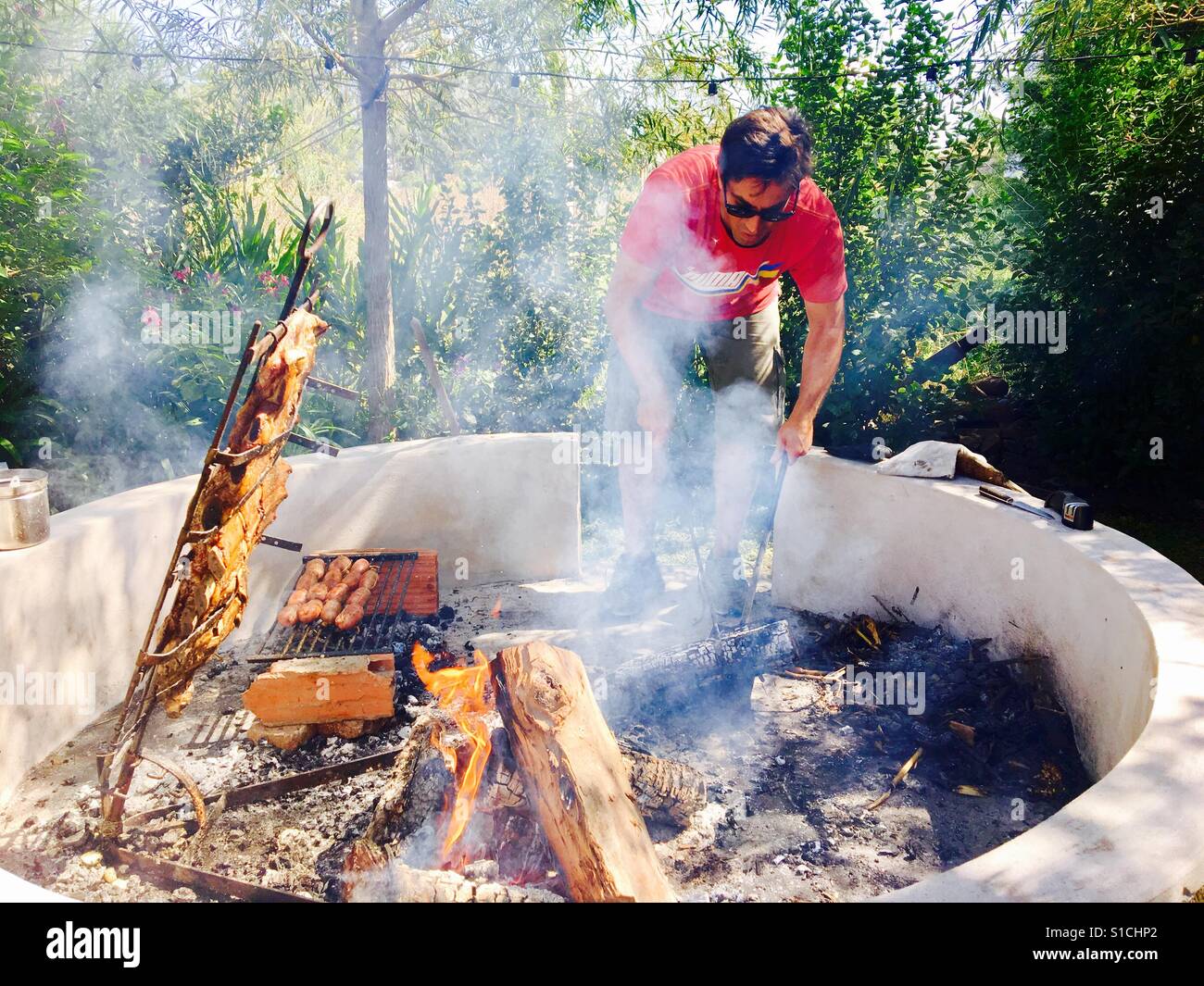 Person roasting meat on grill Stock Photo Alamy