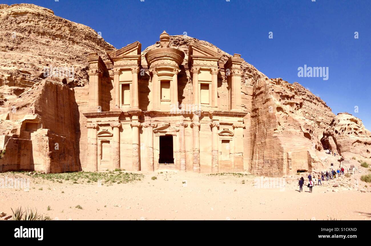 A group of tourist arriving to the Monastery building in Petra after a long hike up the mountain. - Smartphone Captured Stock Image