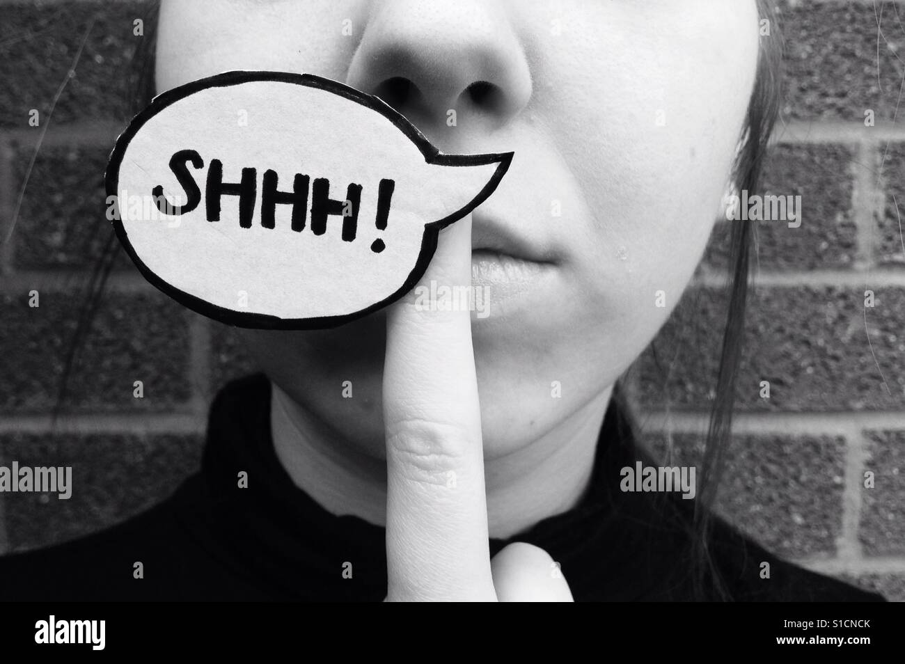 Young woman with shhh! Speech bubble Stock Photo