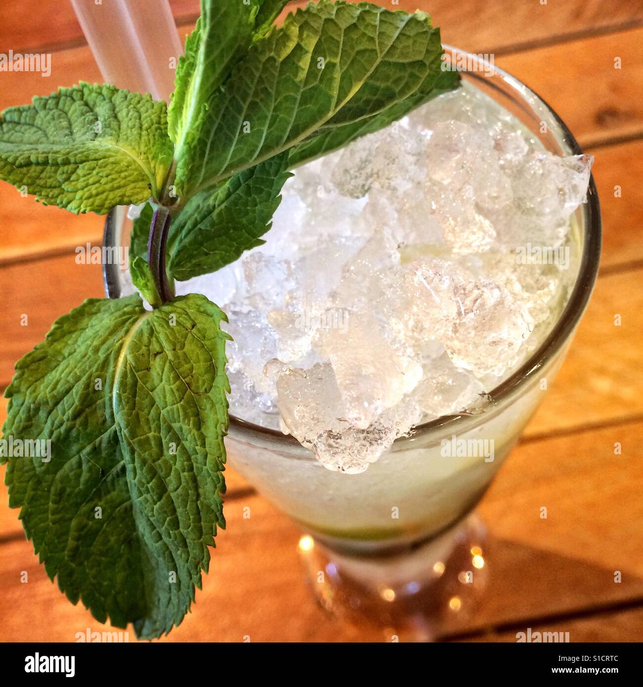 Glass of ice lemonade topped with mint leaves - Smartphone Captured Stock Image