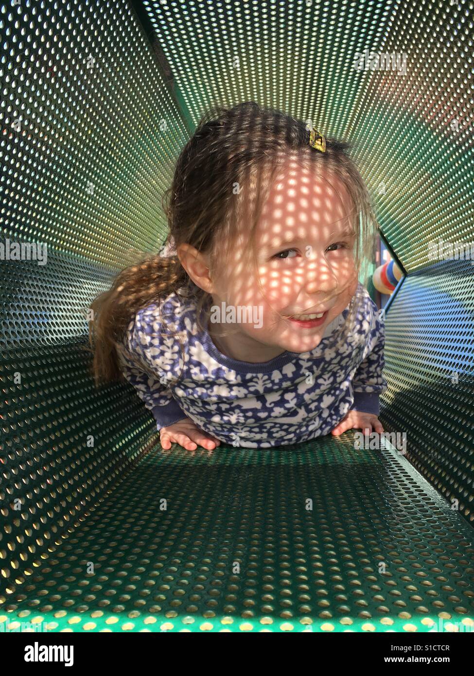 Young girl playing in the tubes Stock Photo Alamy