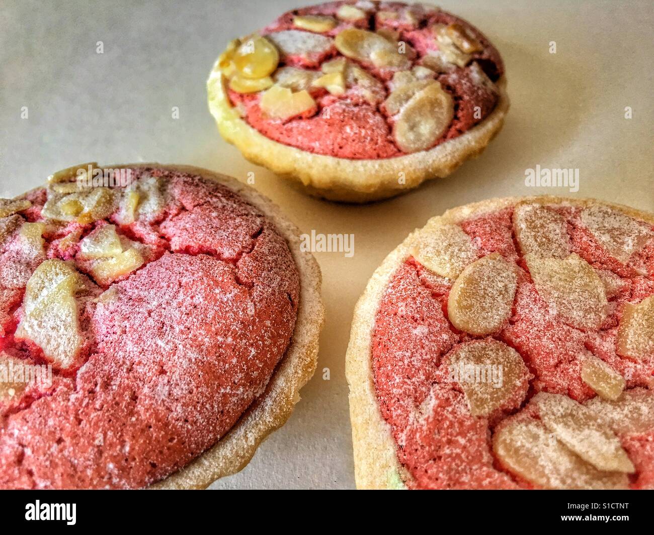 Three raspberry an almond macaroon tarts - Smartphone Captured Stock Image