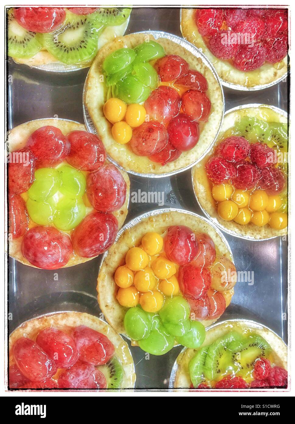 Fruit flans on sale at supermarket. - Smartphone Captured Stock Image