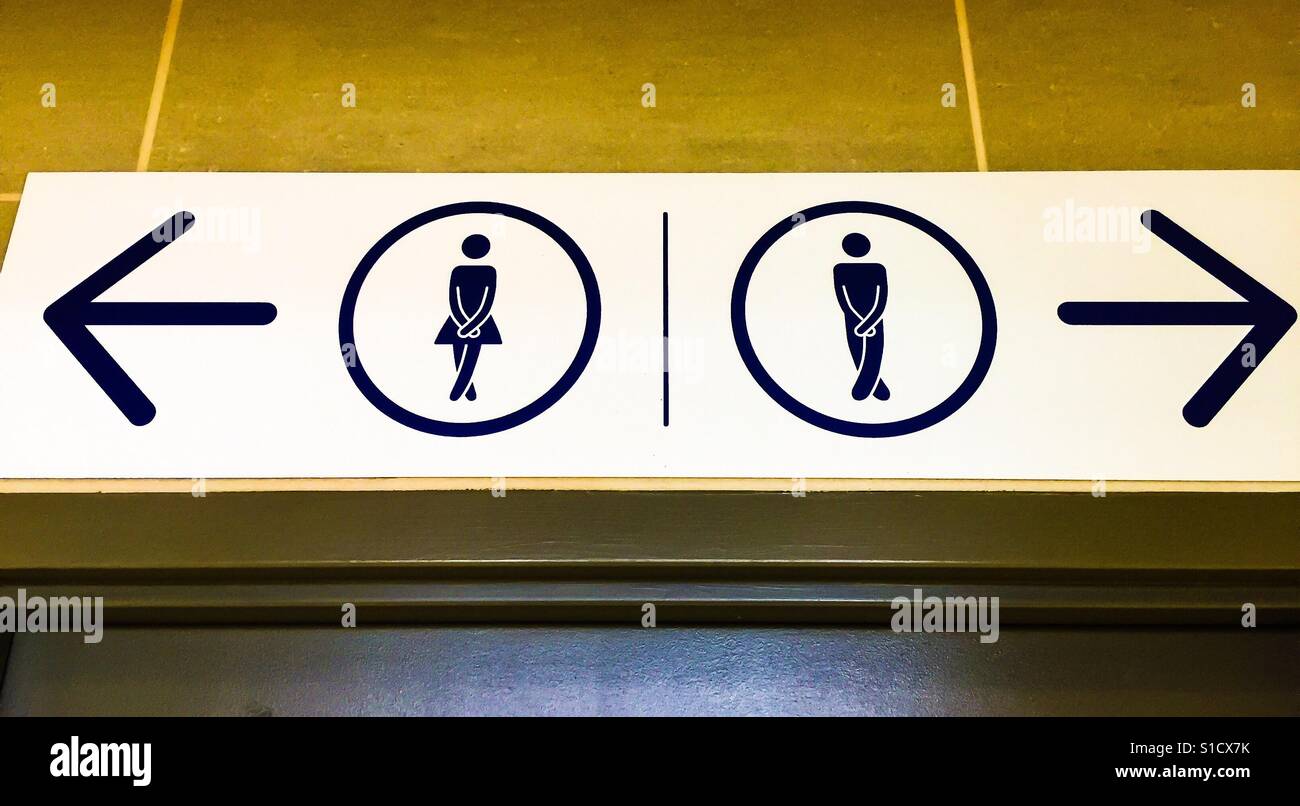 Crossed Legs, MF. Contemporary washroom signs, Canada. Pictogram. No words. Two circles and two arrows. Geometry of space. - Smartphone Captured Stock Image