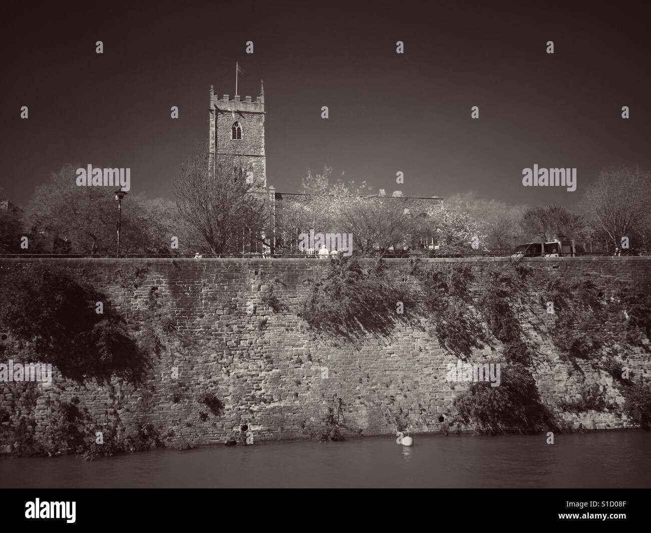 A sepia photograph of the ruins of St Peter's church, which was destroyed in an air raid during World War II, overlooking the Floating Harbour in Bristol, UK - Smartphone Captured Stock Image