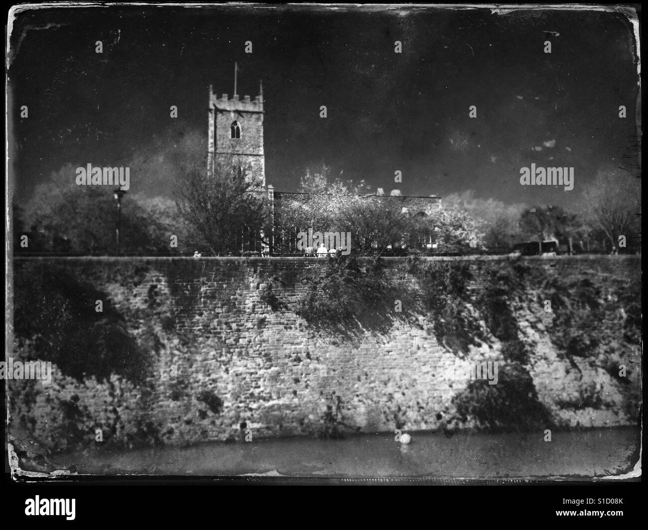 A faux tintype photograph of the ruins of St Peter's church, which was destroyed in an air raid during World War II, overlooking the Floating Harbour in Bristol, UK - Smartphone Captured Stock Image