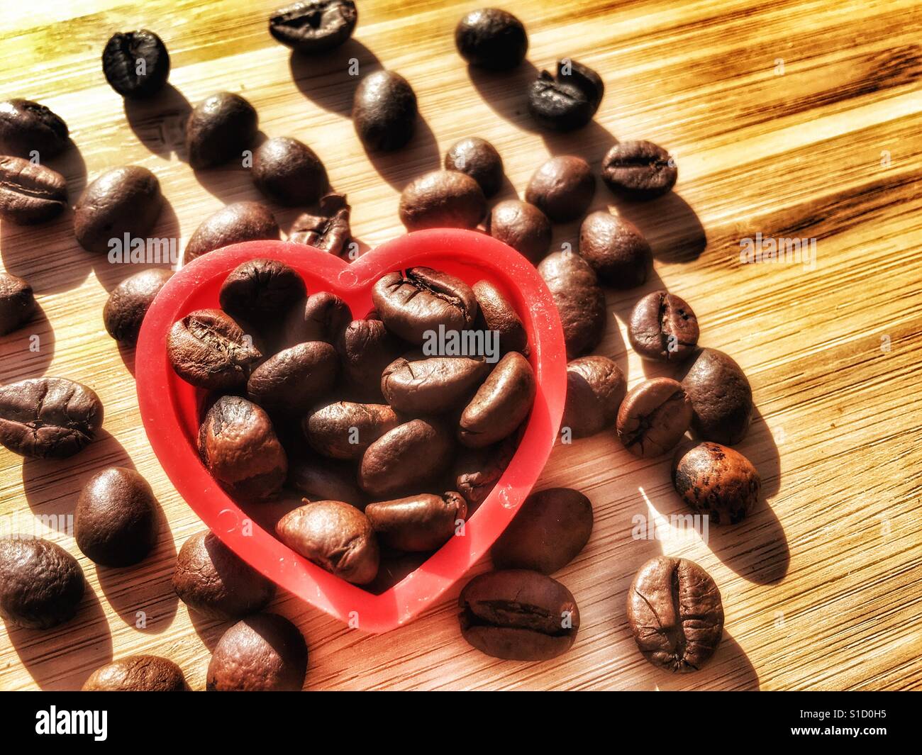 Coffee beans in red heart shape - Smartphone Captured Stock Image
