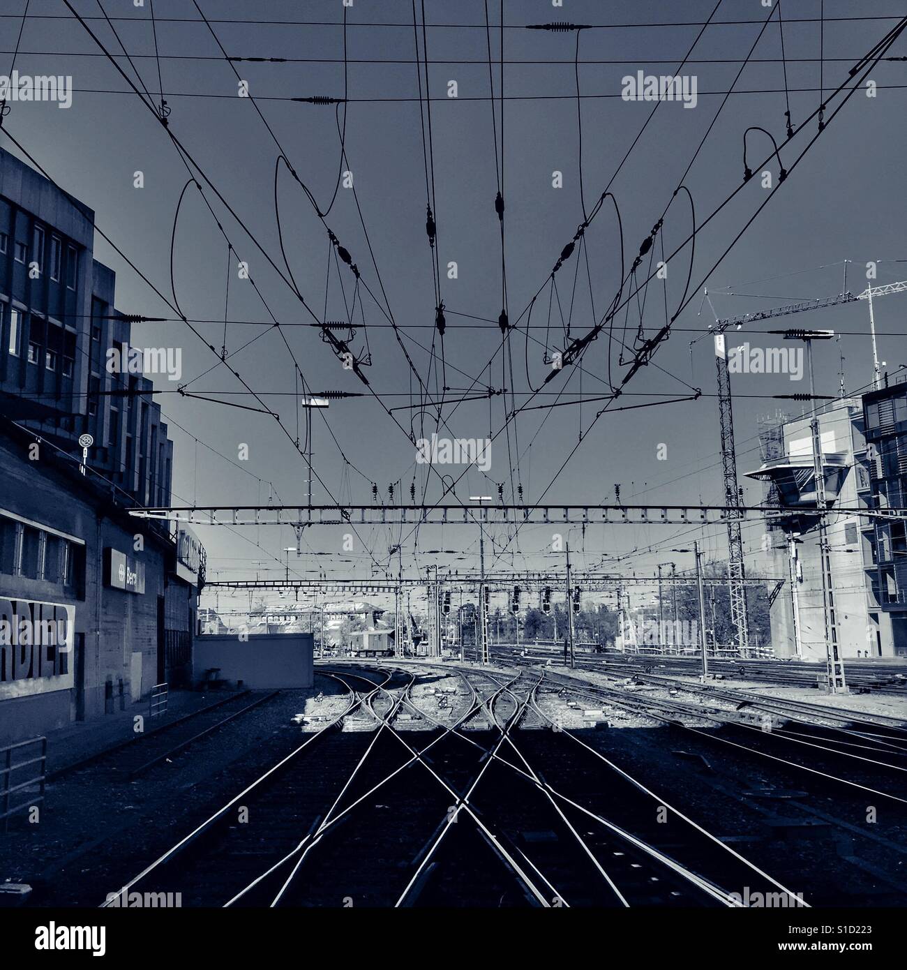 Converging railway tracks and a tangle of overhead wires - Bern station, Switzerland Stock Photo