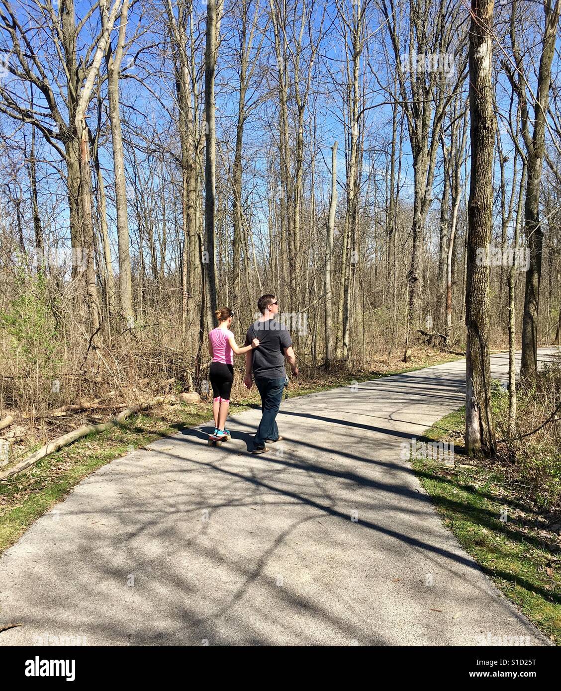 Father and daughter walking along the bike trail in Ohio Stock Photo