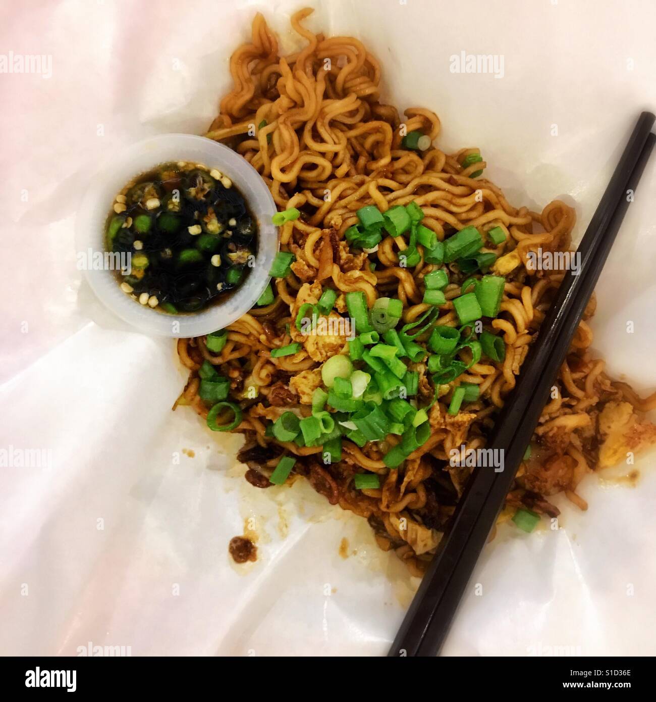 Malaysian street food fried noodles served on greaseproof paper wrap - Smartphone Captured Stock Image