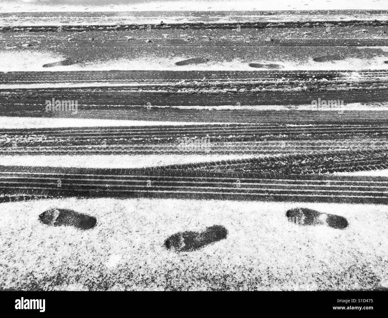Footprints and tyre tracks in the snow. New Jersey, USA. Stock Photo