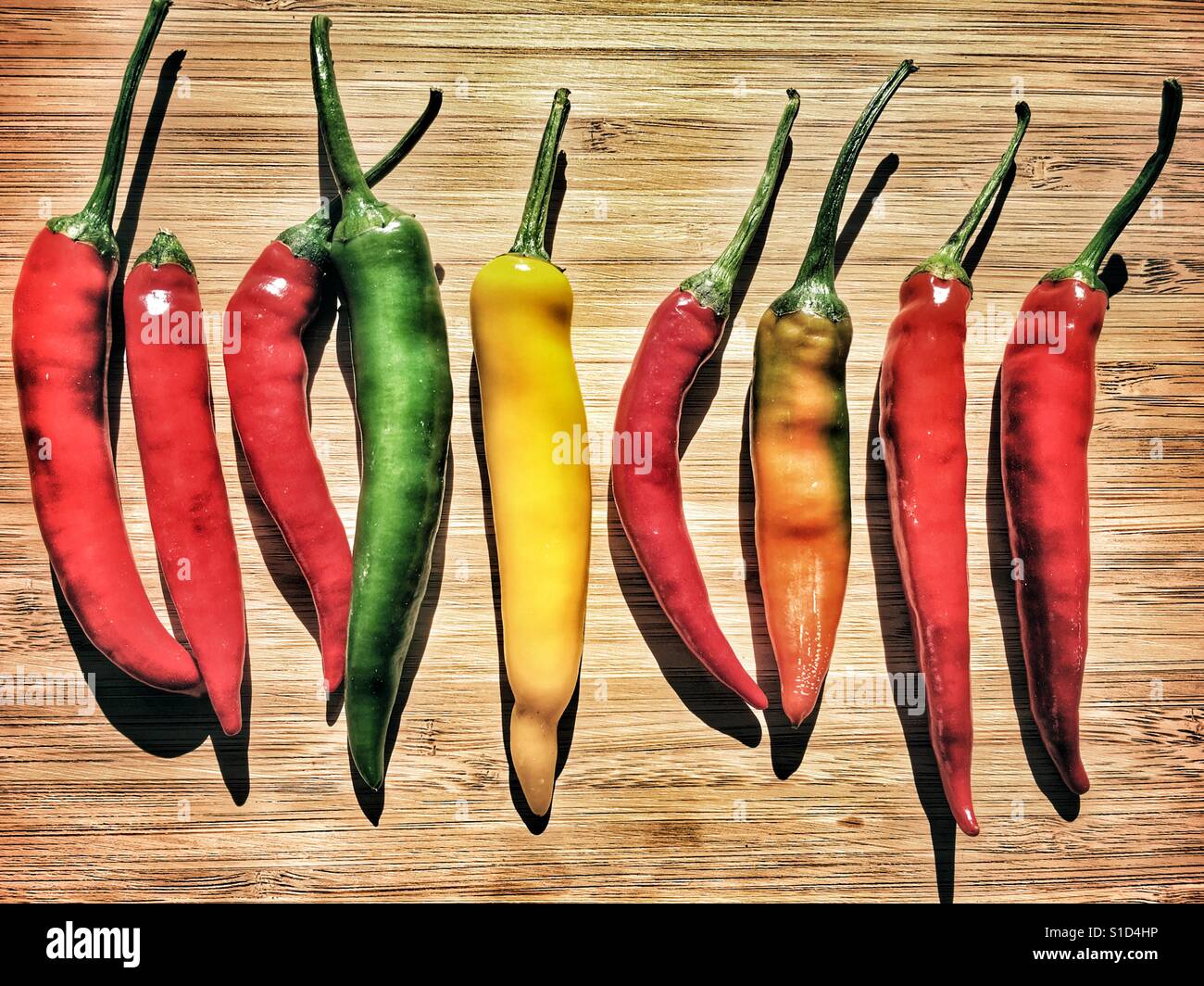 Chilli peppers on a bamboo chopping board - Smartphone Captured Stock Image