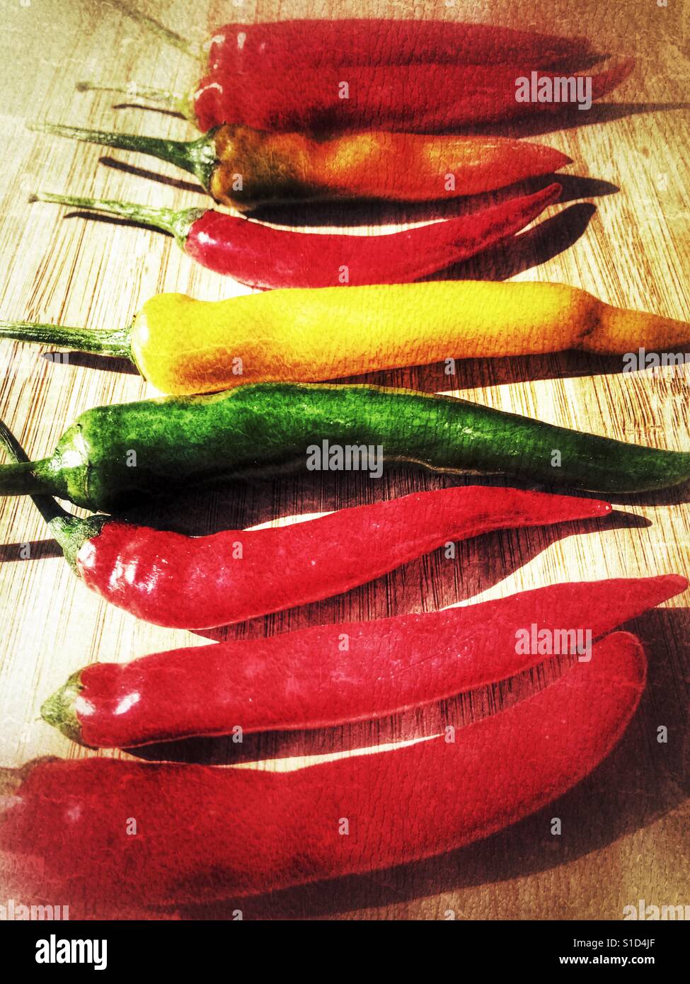 Red hot chilli peppers on a bamboo board - Smartphone Captured Stock Image