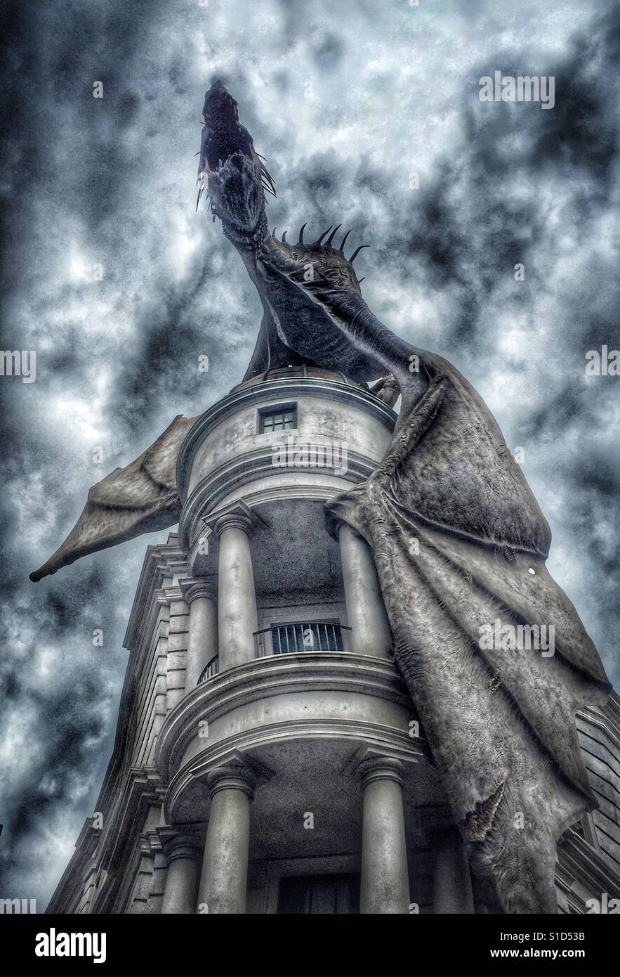 A large dragon sits atop Gringott's Bank at the Wizarding World of Harry Potter at Universal Studios in Orlando, Florida Stock Photo