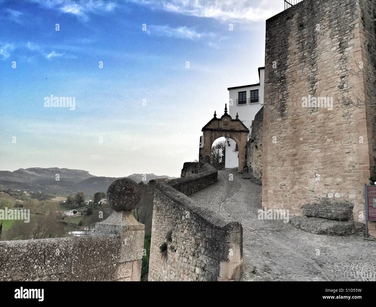 Stone arch in Ronda old town, Andalucia, Spain, with landscape beyond - Smartphone Captured Stock Image