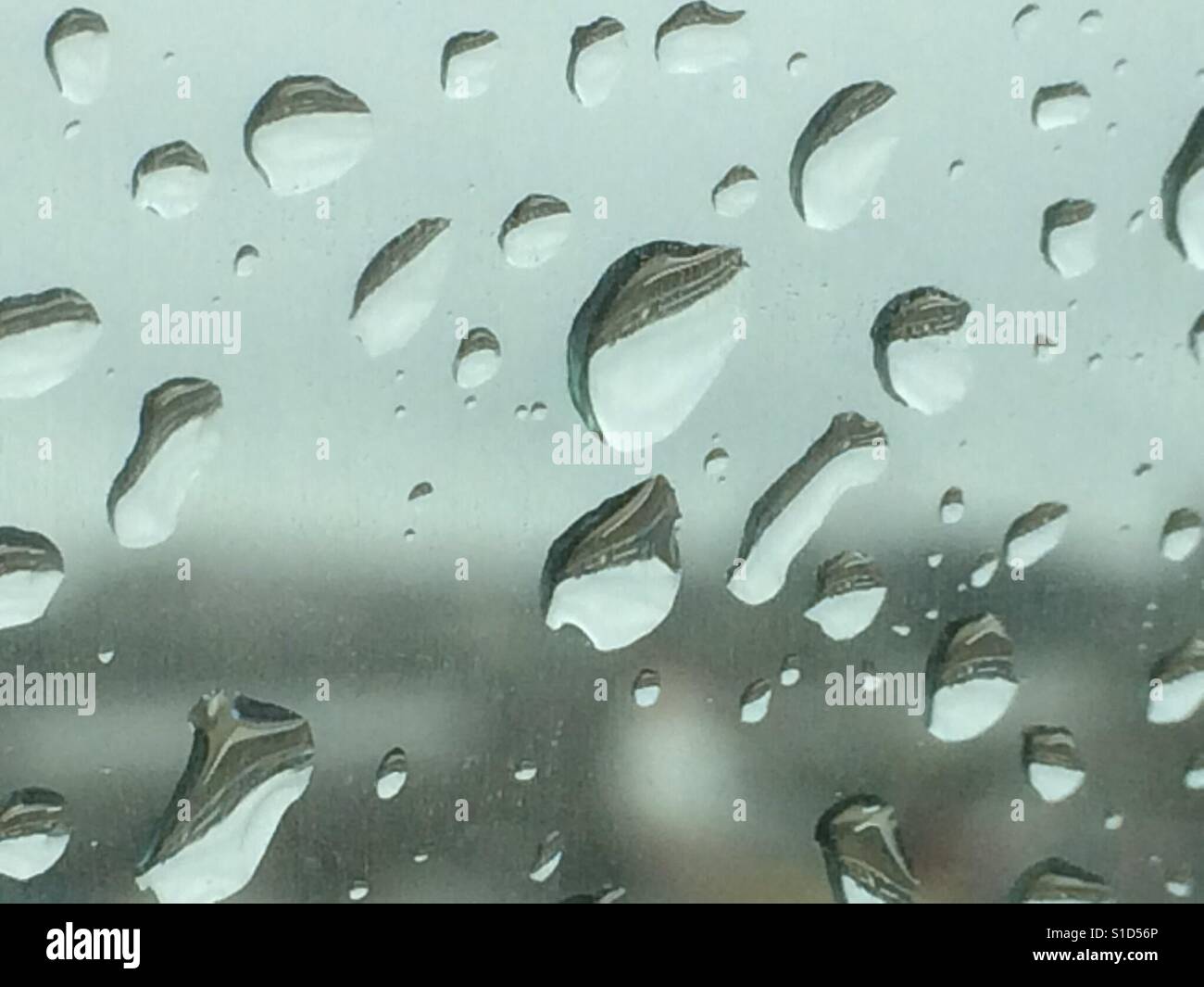 Rain dropS on the car window on a Rainy day - Smartphone Captured Stock Image