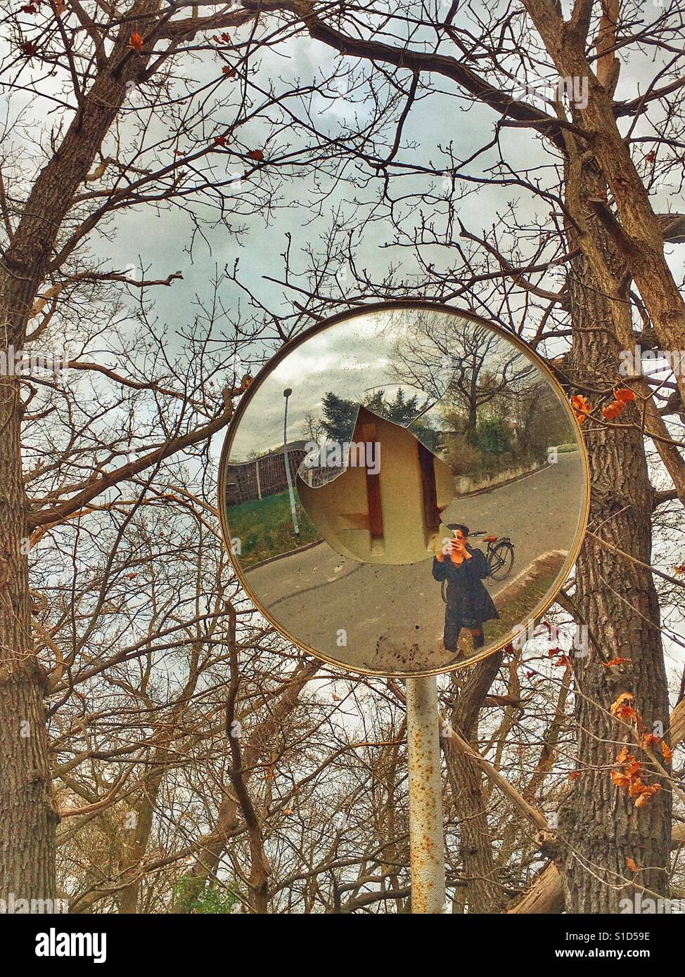 Selfie in a broken traffic mirror Stock Photo