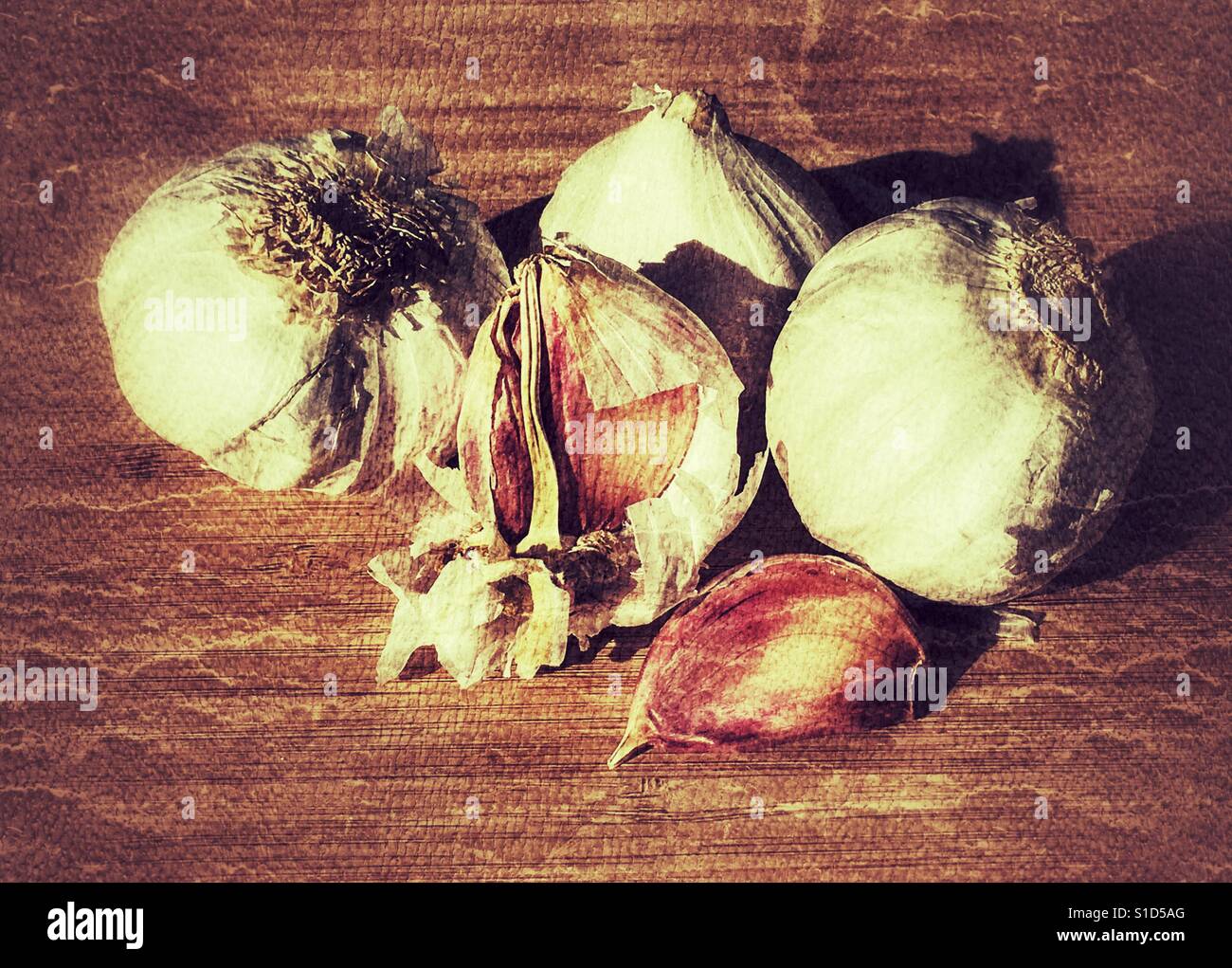 Garlic bulbs and cloves on a bamboo chopping plant - Smartphone Captured Stock Image