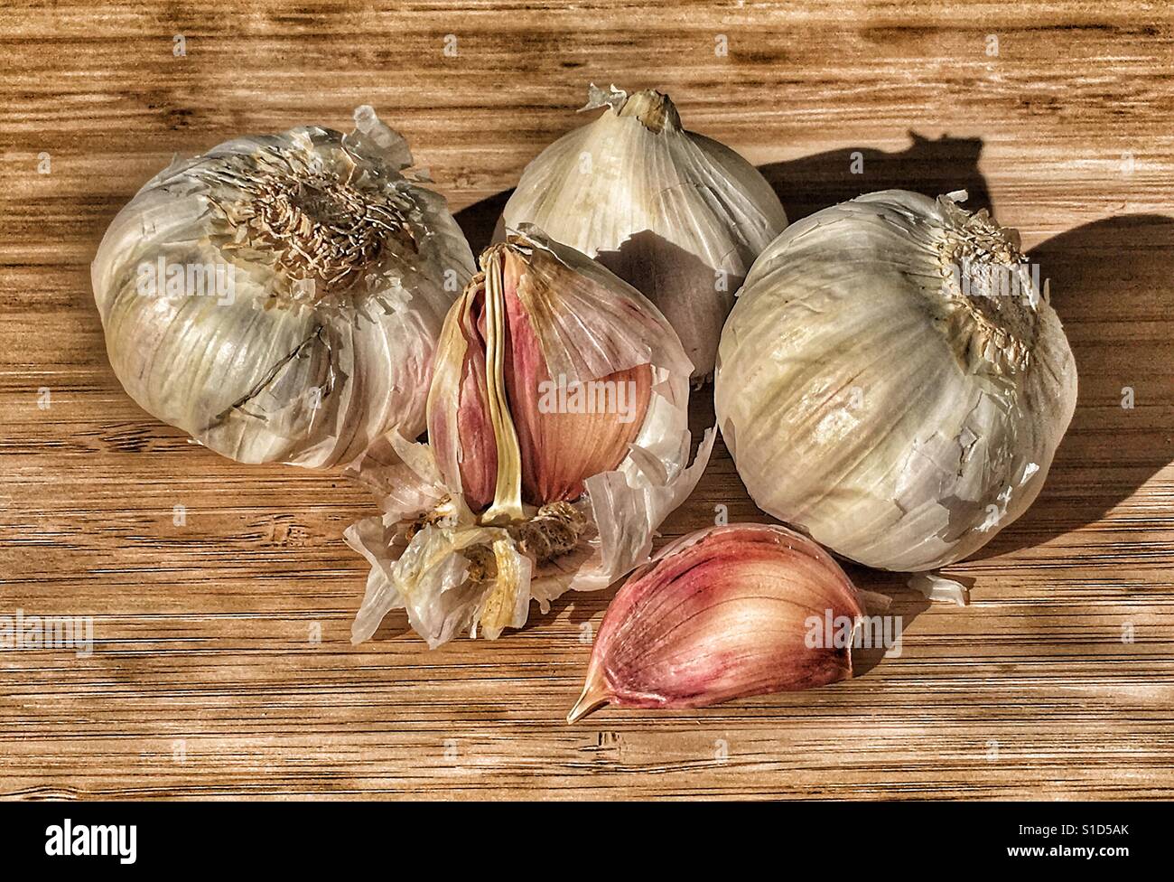 Garlic on a bamboo chopping board - Smartphone Captured Stock Image