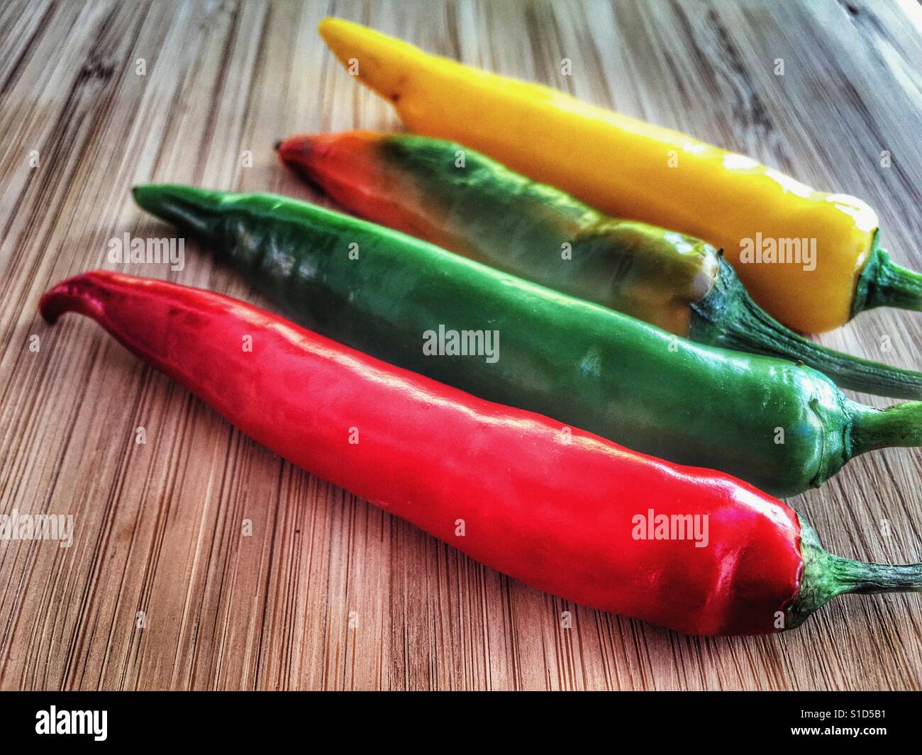 Fresh chillies on a bamboo chopping chopping board - Smartphone Captured Stock Image