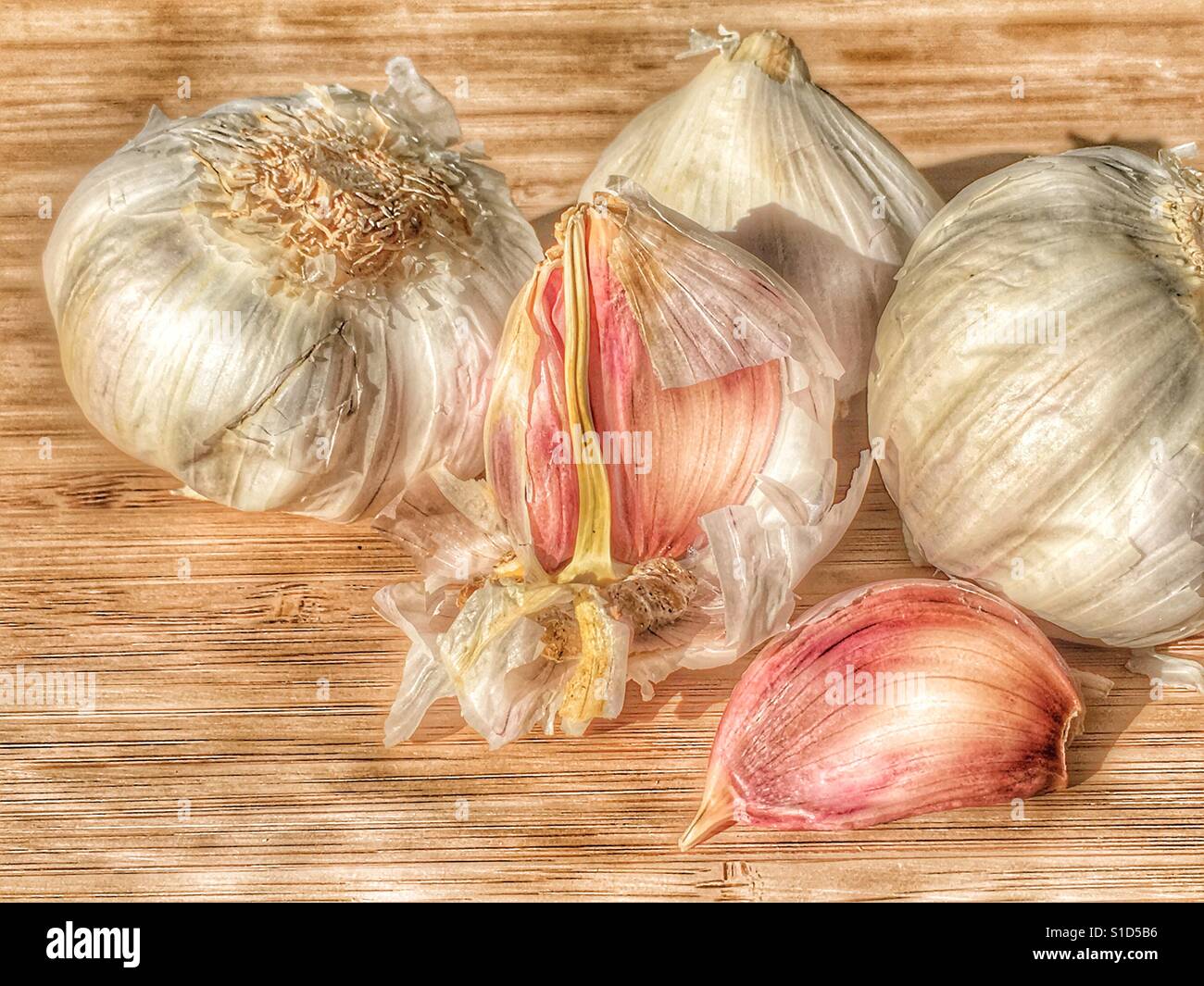 Garlic on a bamboo chopping board - Smartphone Captured Stock Image