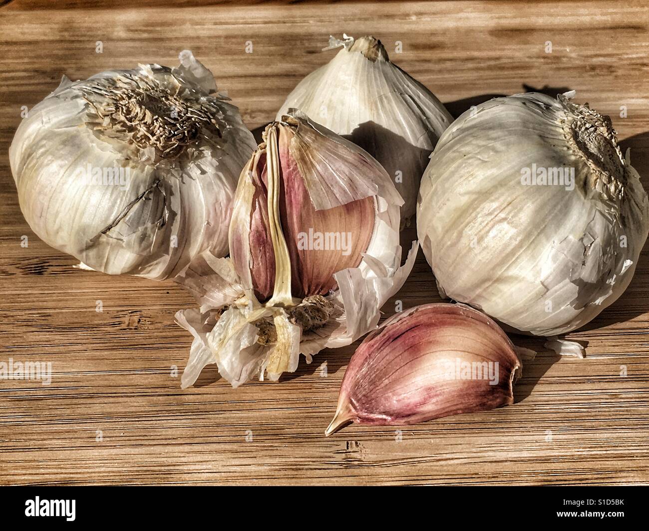 Fresh garlic on a bamboo board - Smartphone Captured Stock Image