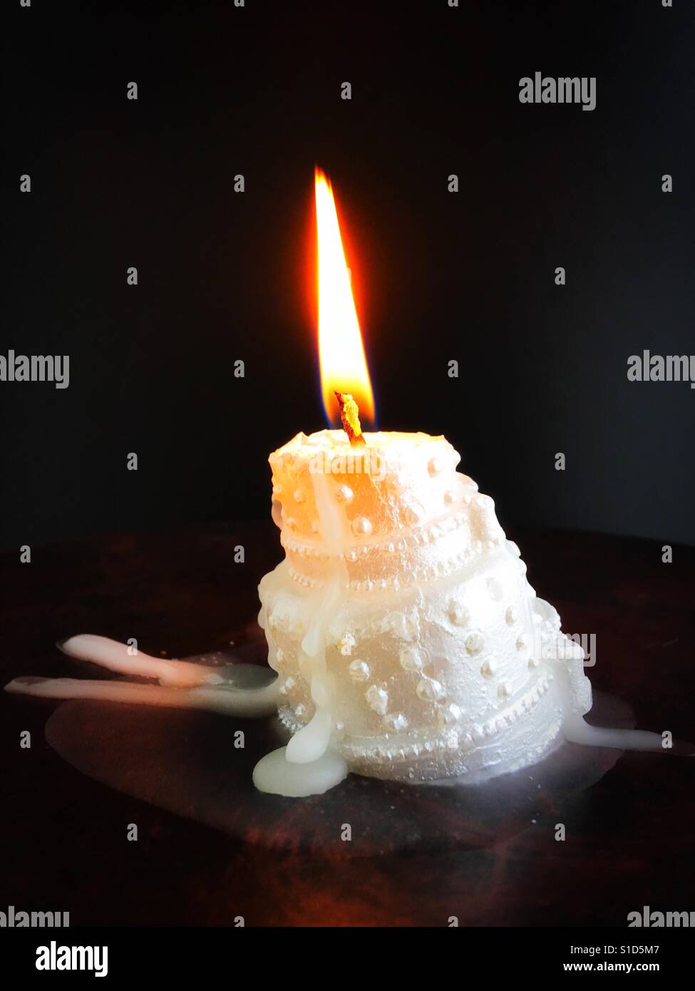 3d Rendering Of A Melting Wax Candle On A Blue Background. Free