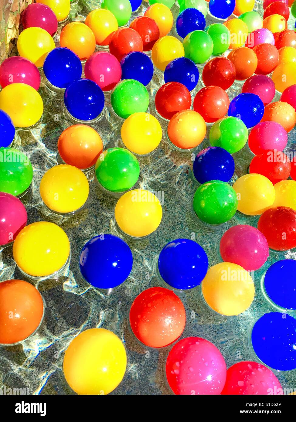 Colorful plastic balls floating on water - Smartphone Captured Stock Image