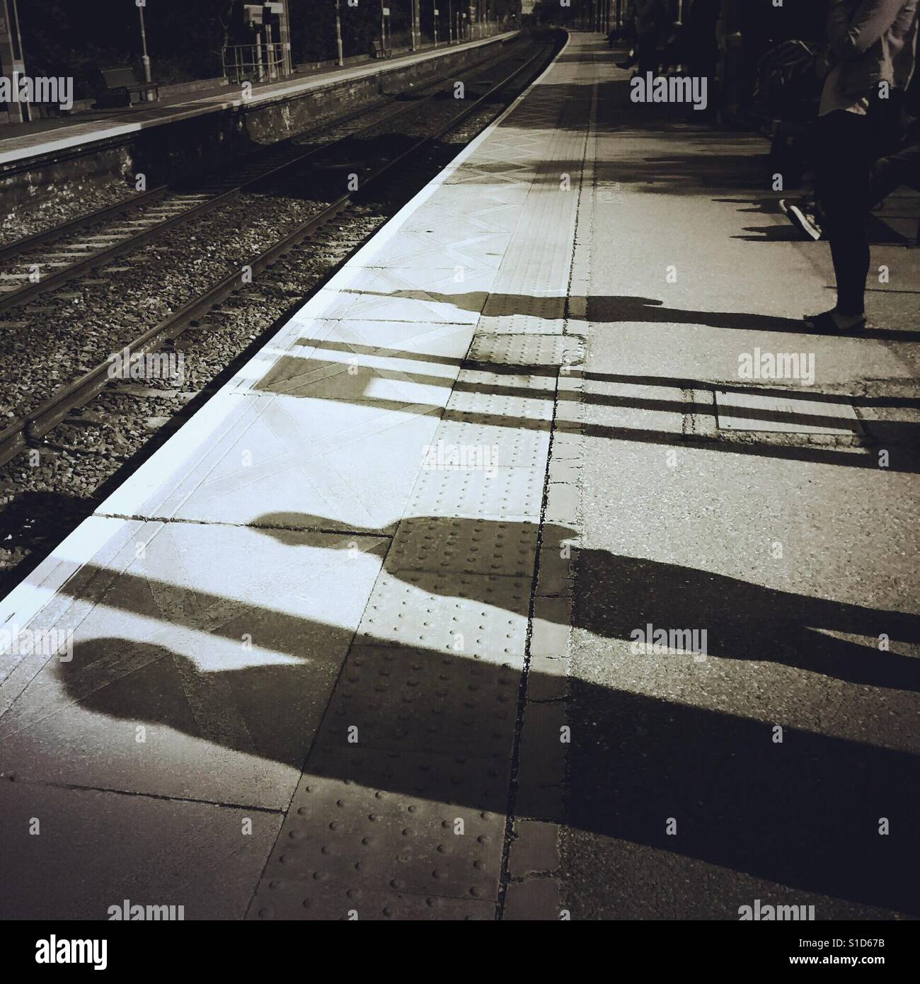 Shadows of people Waiting for an overground train, sawbridgeworth, Hertfordshire, uk - Smartphone Captured Stock Image