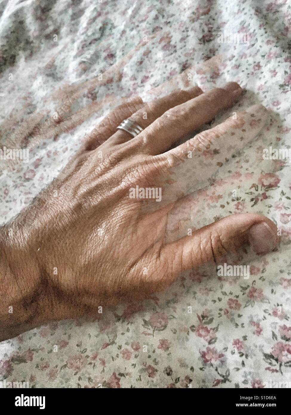 Man's hand with a motion effect, on a vintage fabric. - Smartphone Captured Stock Image
