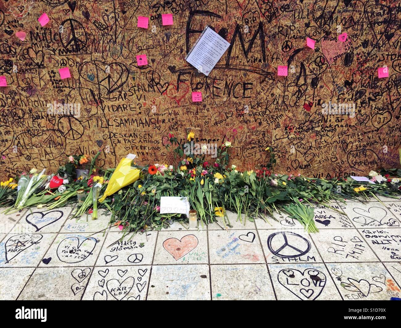 Flowers and messages after Stockholm truck terrorist attack. The board covers damage to shop from truck. - Smartphone Captured Stock Image