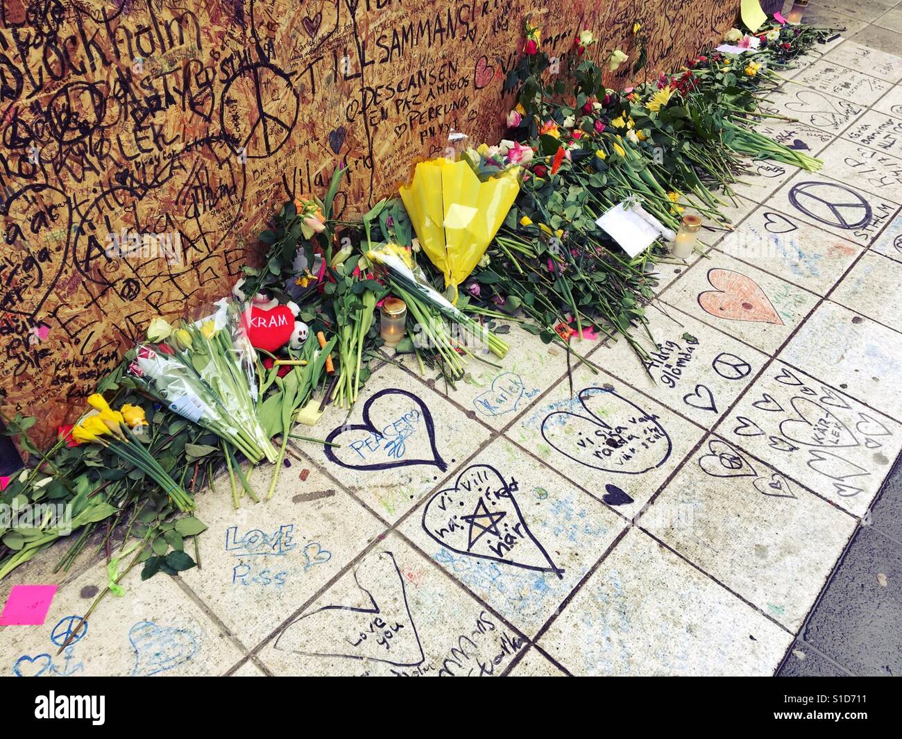 Flowers at crash site of Stockholm terrorist truck attack 2017 with messages and peace symbols. Sweden. - Smartphone Captured Stock Image