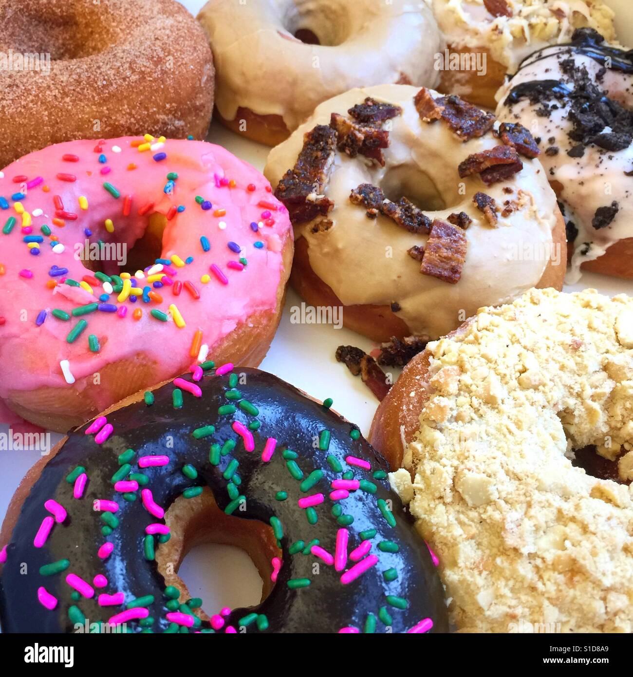 Colorfully decorated donuts with icing and sprinkles - Smartphone Captured Stock Image