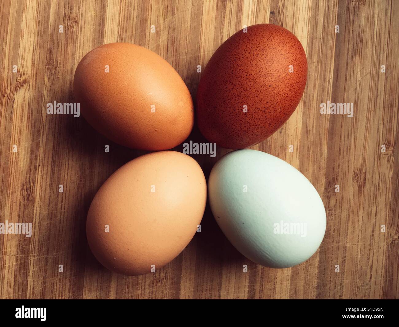 Four eggs on a wooden surface - Smartphone Captured Stock Image