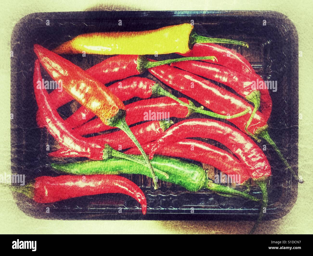 Chillies in black plastic packaging - Smartphone Captured Stock Image