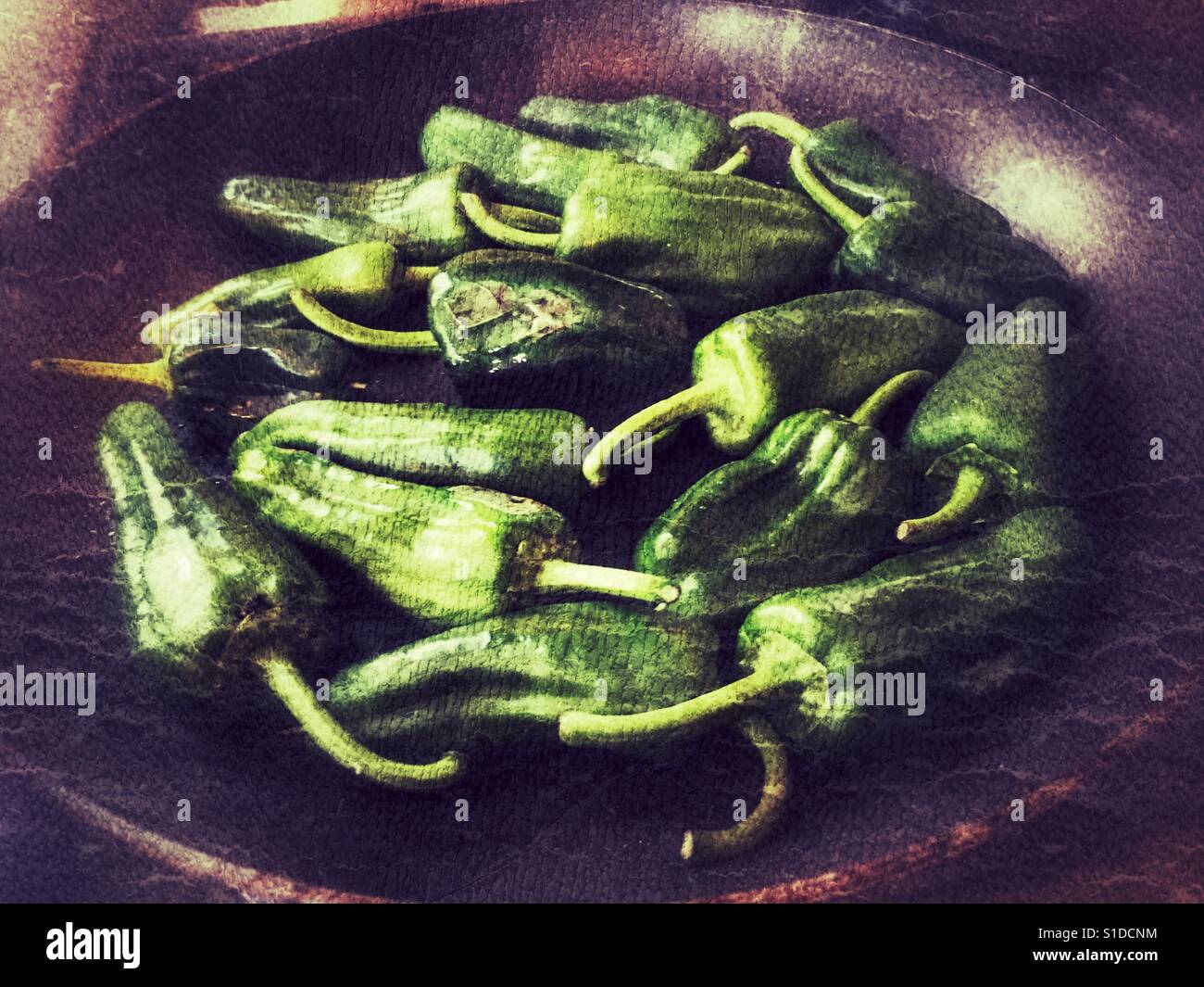 Pimientos de Padron, Capsicum annum, from Galicia. In a frying pan prior to being cooked. - Smartphone Captured Stock Image