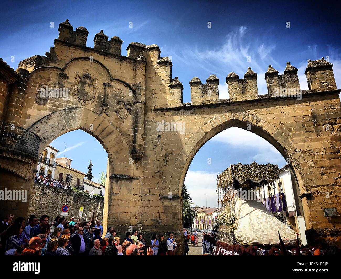 An image of the Virgin Mary enters a door of the antique city of Baeza during Easter Holy Week in Baeza, Jaen province, Andalusia, Spain - Smartphone Captured Stock Image