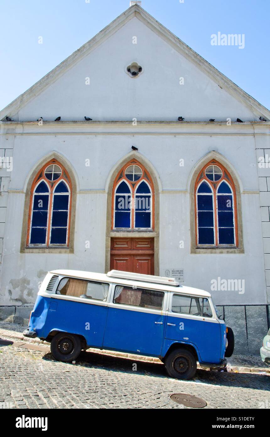 A vintage Volkswagen camper van parked in a sloping street in Lisbon, Portugal - Smartphone Captured Stock Image
