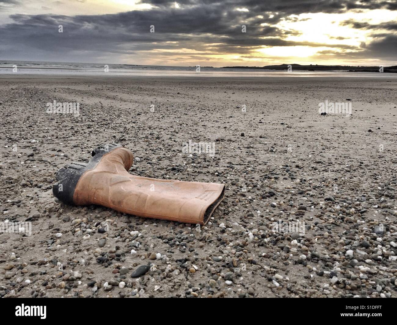 Wellington boot on Cymyran beach, Anglesey, North Wales - Smartphone Captured Stock Image