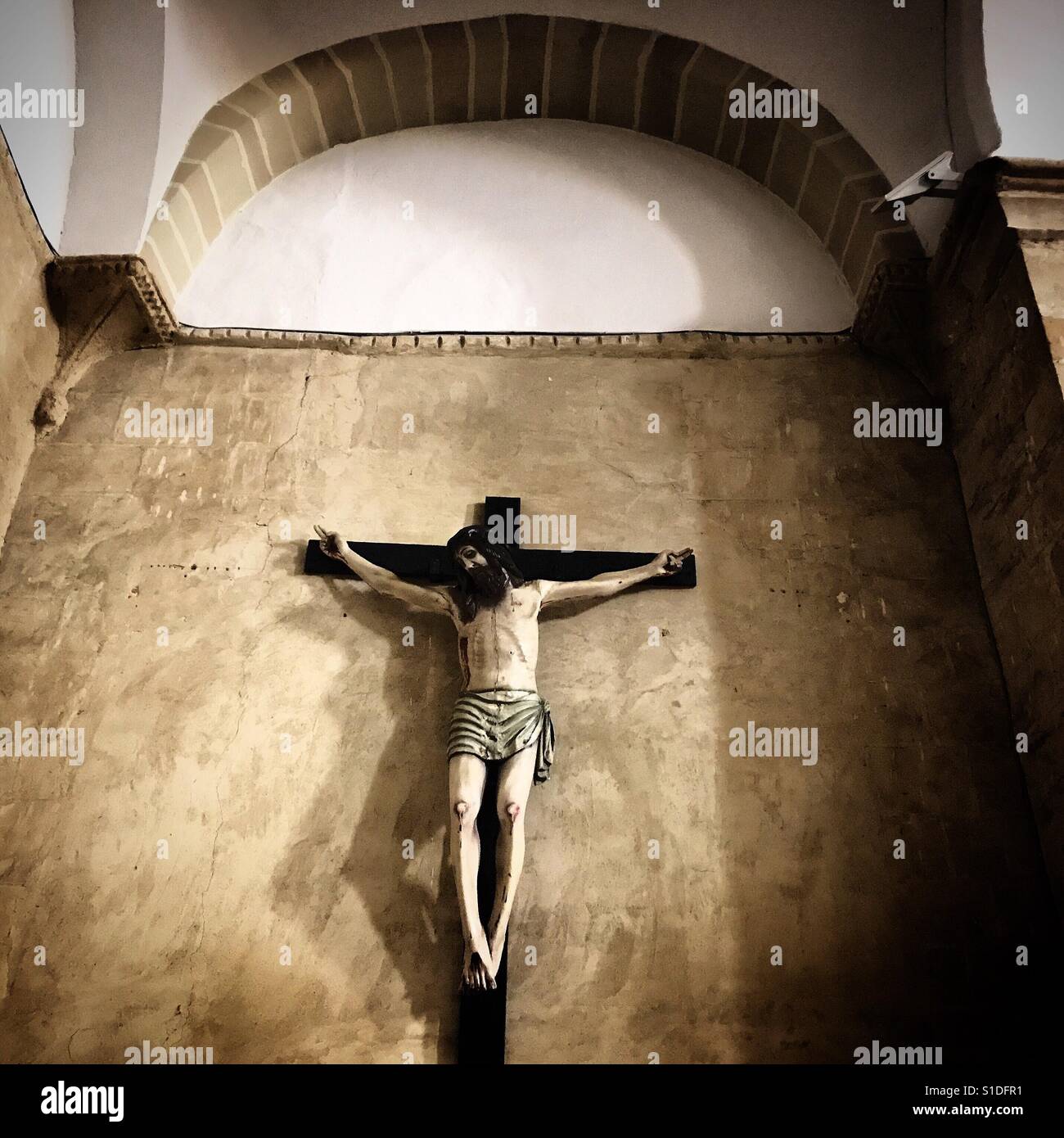 A sculpture of a bearded Jesus Christ crucified decorates a church in ...