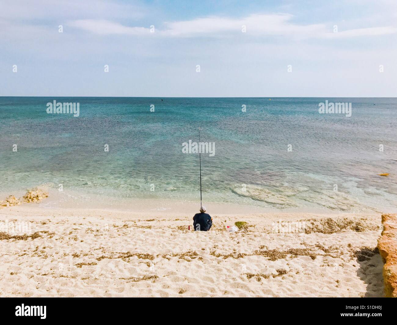 Man fishing by the sea - Smartphone Captured Stock Image